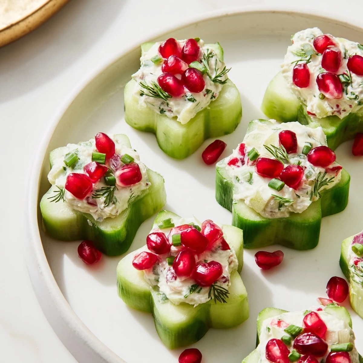 Elegant appetizer featuring beautiful snowflake-shaped cucumber cups brimming with a vibrant salad filling.