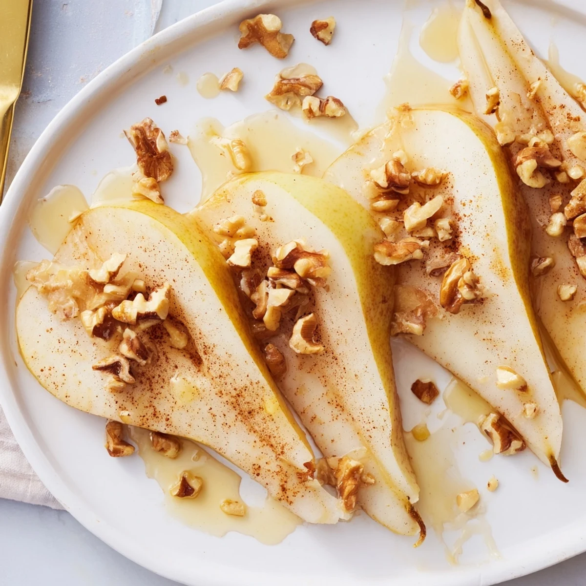 Close-up of elegant pear slices and honey drizzle, inviting you to taste this simple dessert creation.