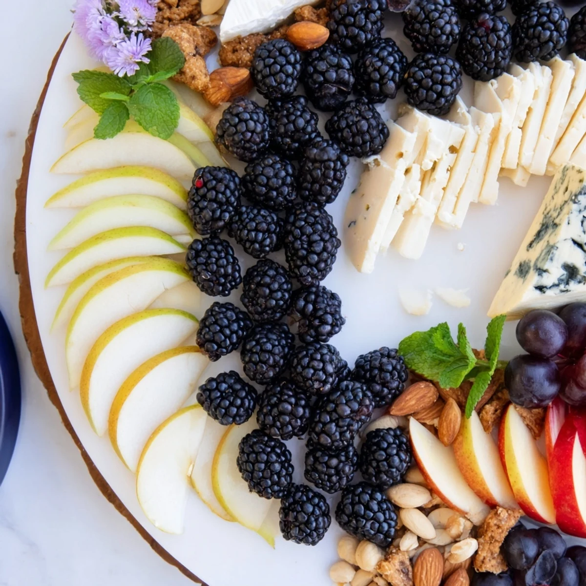A stunning Yin-Yang Balance appetizer board showcasing contrasting cheeses, fruits and crackers.