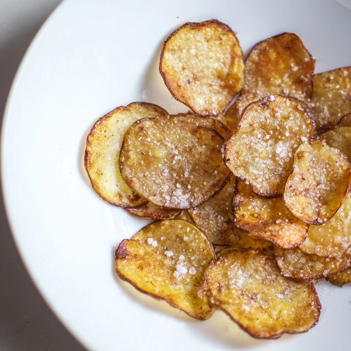 Homemade, golden air-fryer potato chips, seasoned and ready to enjoy with your favorite dipping sauce.