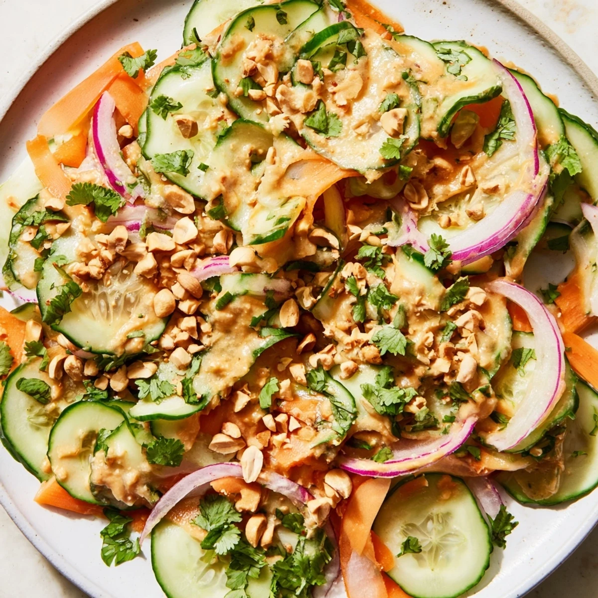 Fresh Thai-Style Peanut Cucumber Salad, vibrant with cilantro and peanuts, tossed in creamy peanut dressing.