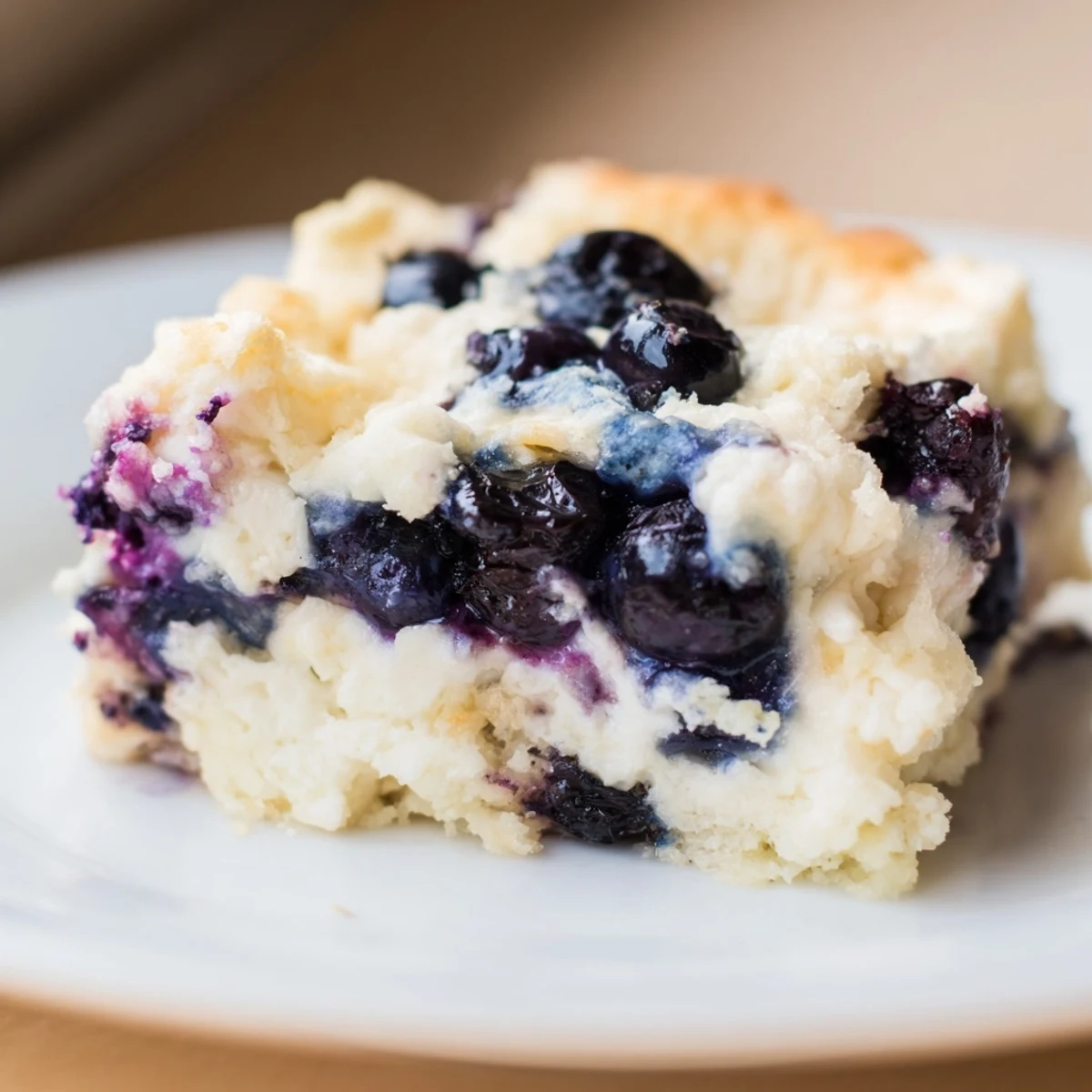 Golden Blueberry Cottage Cheese Bake, with visible blueberries and a creamy texture, perfect for breakfast.