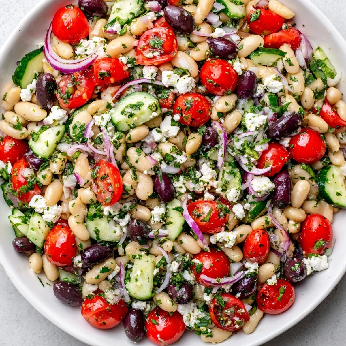 Creamy White Bean Salad tossed with fresh herbs and tomatoes, ready to enjoy.