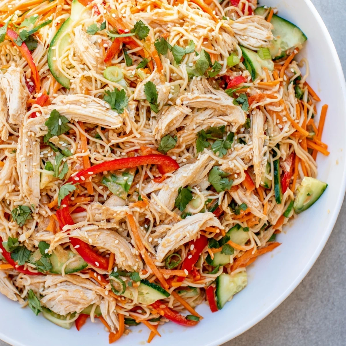 Refreshing Chilled Chicken Noodle Salad showcasing perfectly cooked noodles, shredded chicken, and a tangy sesame dressing.