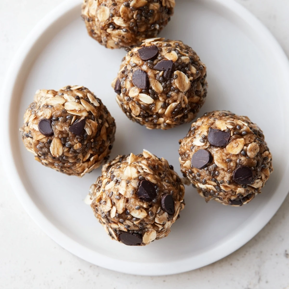 A close-up of chewy Almond-Chia Energy Bites; a gluten-free and dairy-free treat on a tray.