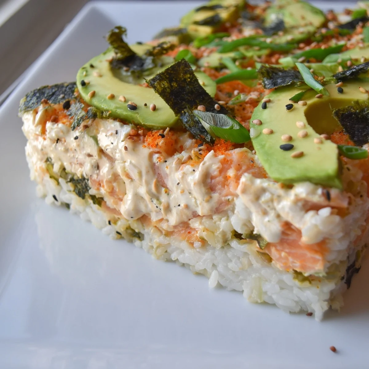 A bubbling Sushi Bake Casserole, showcasing flaky salmon atop seasoned rice ready to be served and enjoyed.