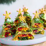 See colorful veggies and cheese inside these Air Fryer Christmas Tree Tortilla Wraps alongside pretzel "tree trunks."