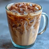 2. A refreshing iced espresso drink featuring brown sugar syrup, frothy oat milk, and a hint of cinnamon, perfect for warm days.