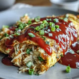 Fluffy omelet cradling savory ketchup rice, a delightful comfort food.