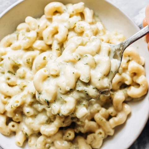A warm bowl of Pickle Mac and Cheese, creamy, cheesy, and studded with dill pickles.
