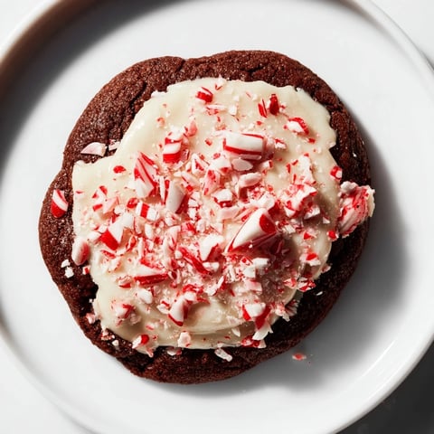 Freshly baked Peppermint Bark Cookies: White chocolate drizzled over rich chocolate cookies, peppermint candies sprinkled.