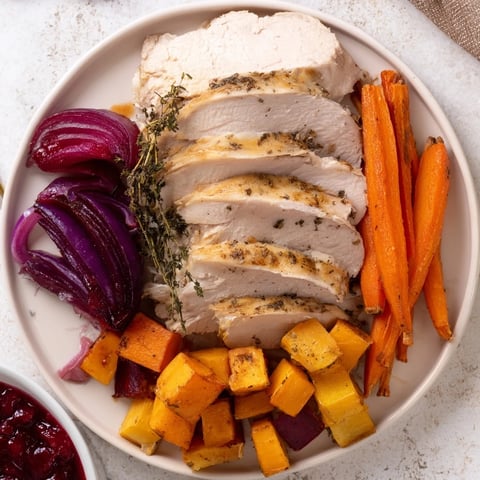A beautifully arranged Harvest Turkey Platter featuring juicy sliced turkey and vibrant roasted vegetables.