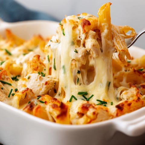 Golden-brown baked Chicken Ranch Pasta Bake with bubbly mozzarella and fresh chives in a 9x13 dish.  