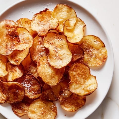 Crispy, seasoned air-fryer potato chips, a healthier alternative to deep-fried, perfect for sharing.
