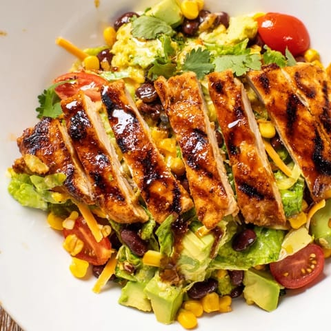 Freshly tossed honey lime chicken taco salad topped with crunchy tortilla strips, diced avocado, and a bright citrus dressing drizzle.  