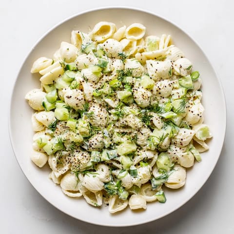 A chilled pasta salad with diced cucumbers, fresh dill, and a sprinkle of everything bagel seasoning for a crunchy finish.  