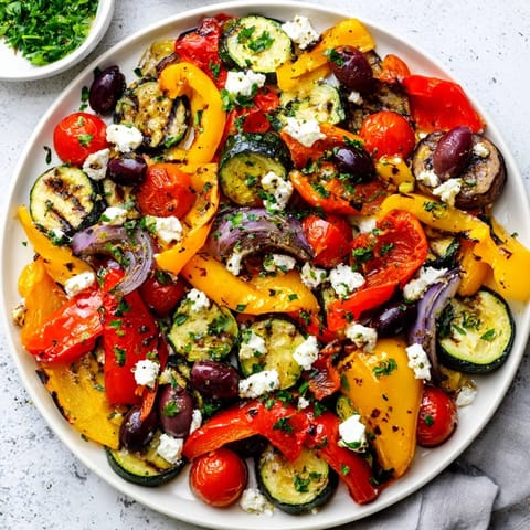 Warm roasted Mediterranean vegetables from the Roasted Greek Salad are tossed with fresh parsley and drizzled with a zesty lemon-oregano dressing.