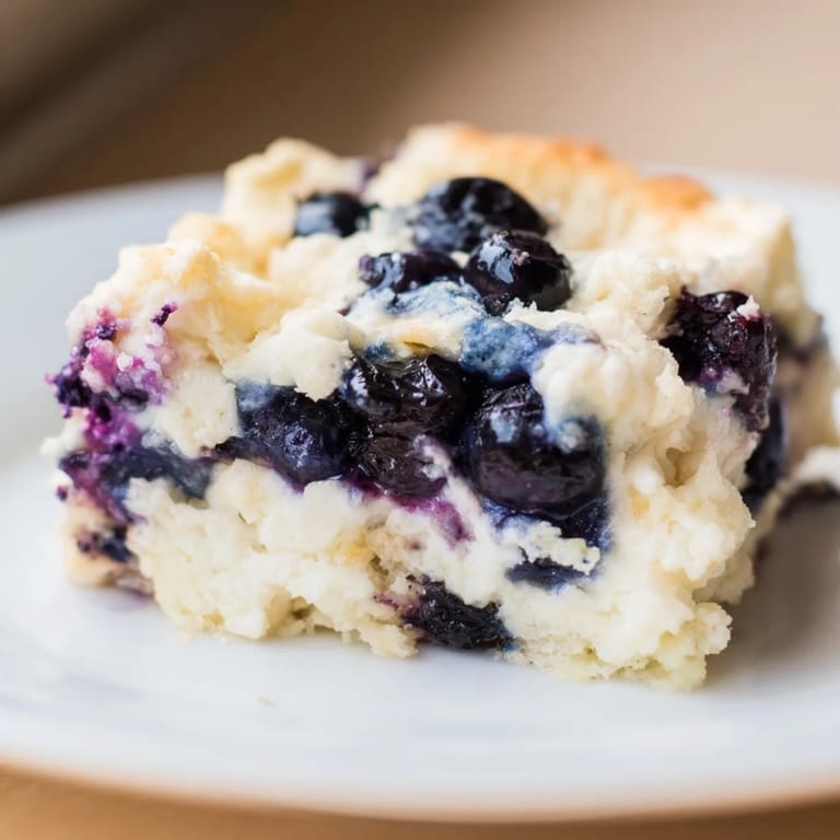 Golden Blueberry Cottage Cheese Bake, with visible blueberries and a creamy texture, perfect for breakfast.