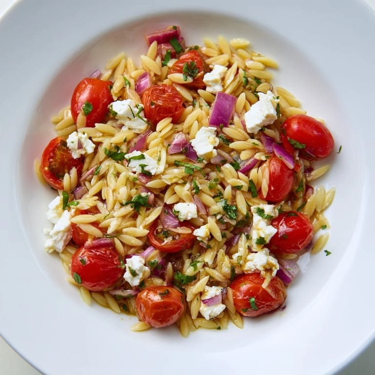 This delicious Tomato Feta Orzo pasta salad is perfect for a light lunch or gathering.