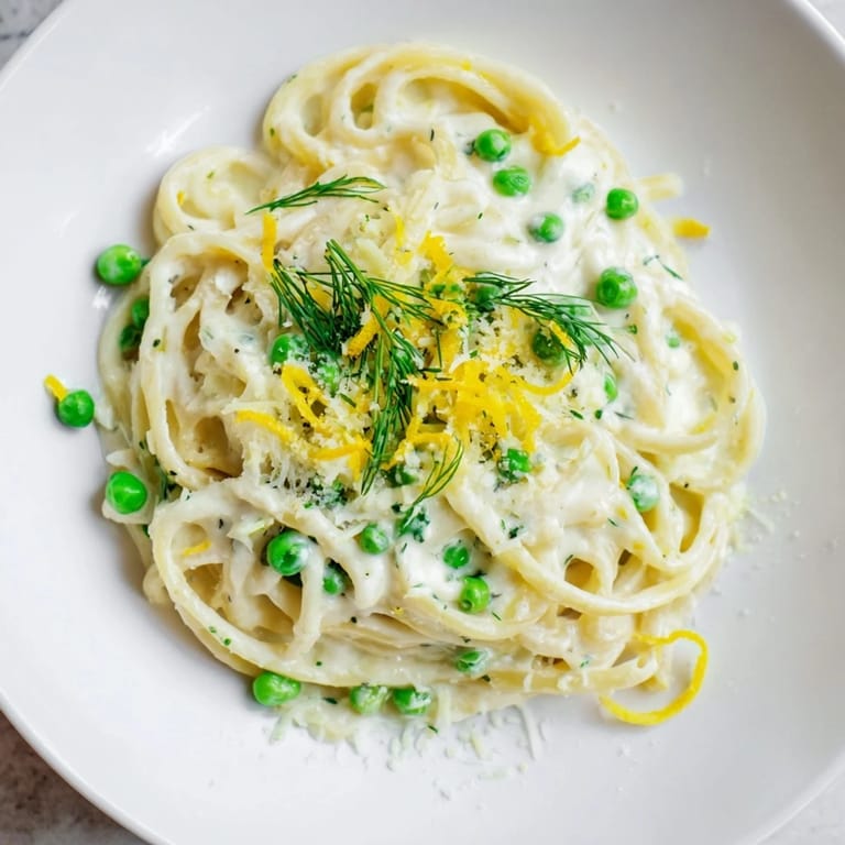 A close-up of Creamy Dill Pasta, showcasing perfectly cooked noodles and vibrant green dill sprigs.