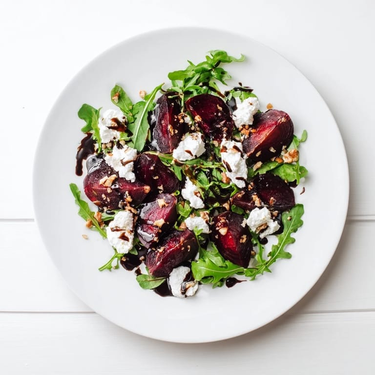 Sliced roasted beets and creamy goat cheese crumbles over a bed of fresh arugula, topped with walnuts and balsamic dressing.  
