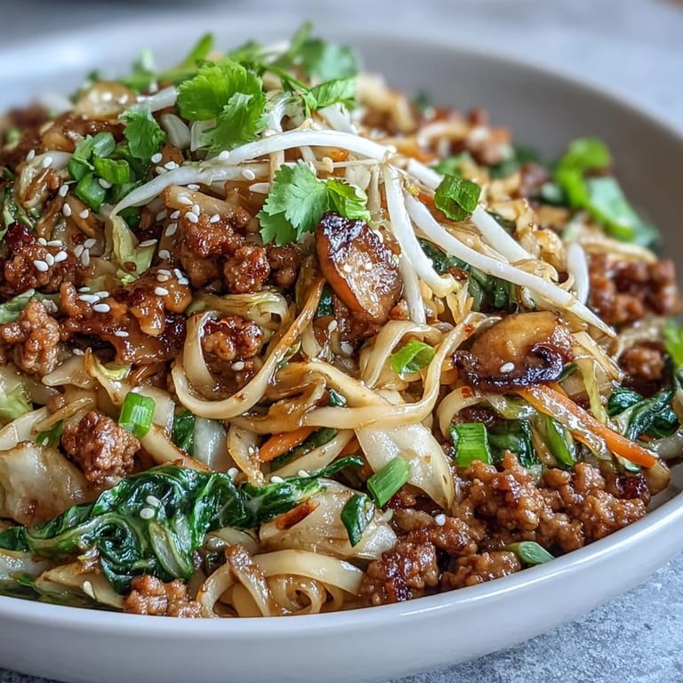 Steaming Potsticker Noodle Bowls featuring tender noodles and vegetables tossed in a savory sauce.